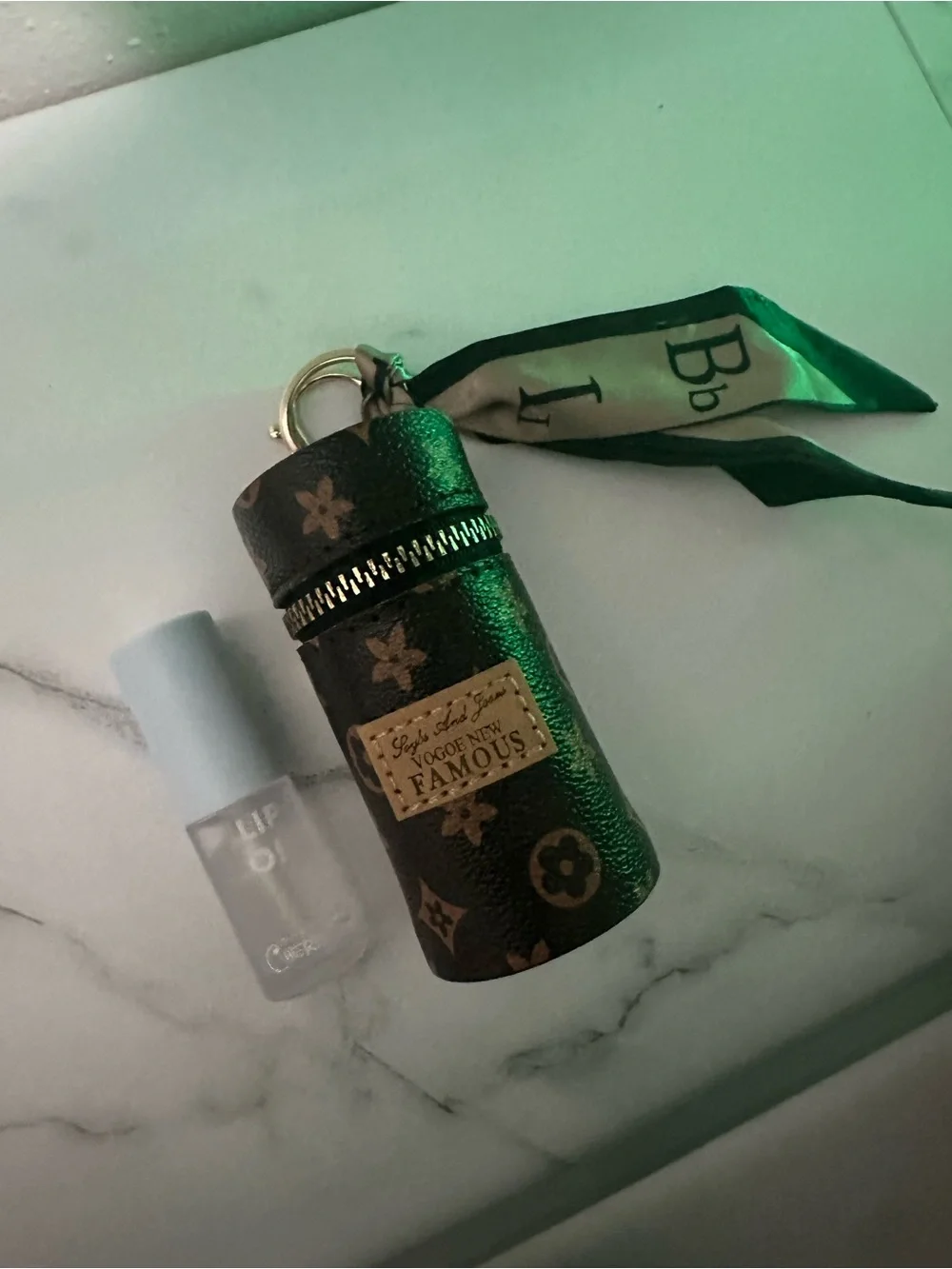 Luxury Monogram Cylinder Keychain Pouch with Silk Scarf with lipgloss.